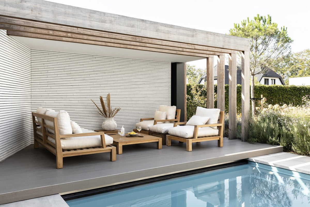 Teak Daylounge garden furniture with light cushions on a terrace, from the Dutch Garden collection